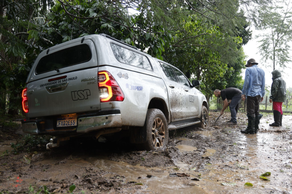 The PyroCarbon Project team works to get the truck unstuck after a heavy downpour. 