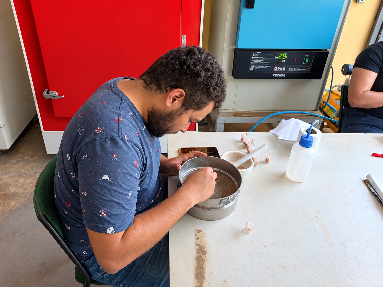 Technician Gabriel preparing and grinding Amazon PyroCarbon soil samples at the laboratory bench